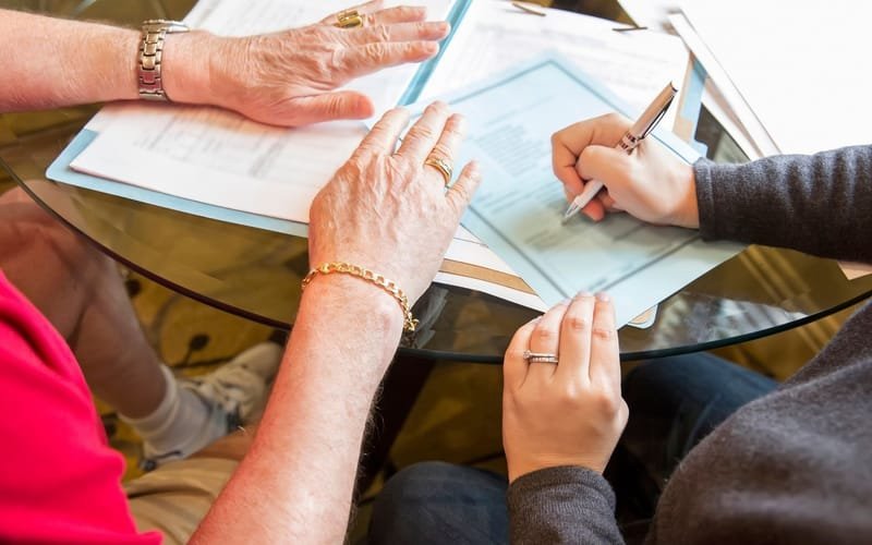 Wills and trusts lawyer meeting with a Florida family signing documents
